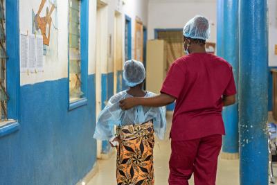 Sia and Sister Samuella walk from the antenatal room to the operating theater.