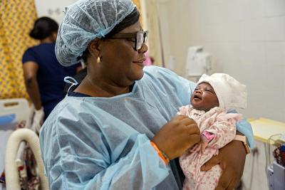 Sister Patricia holds Sia’s baby shortly after birth.