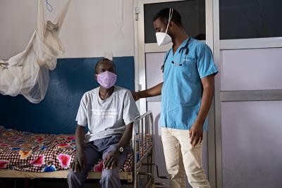 TB/HIV Program Manager Dr. Girum Tefera, right, visits with Mohamed S. Bah.