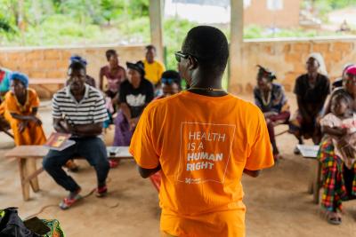 A community health worker educates families about tuberculosis during a community outreach event in Kono District, Sierra Leone.