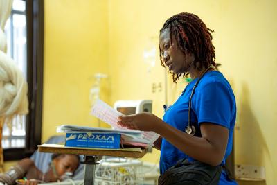 Mariama Gifty Lahai, a critical care nurse in the maternity ward at Koidu Government Hospital, reads a document.