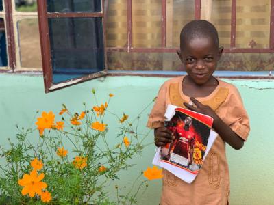 Young boy holding a book