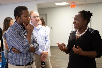 Angeline Charles talking to colleagues