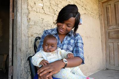 Midwife in Sierra Leone holding baby