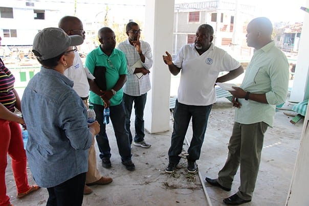 PIH's leadership team in Haiti discusses the damage from Hurricane Matthew with Dr.Jean Yves Domercant (center), medical director of the Immaculate Conception Hospital in Les Cayes.