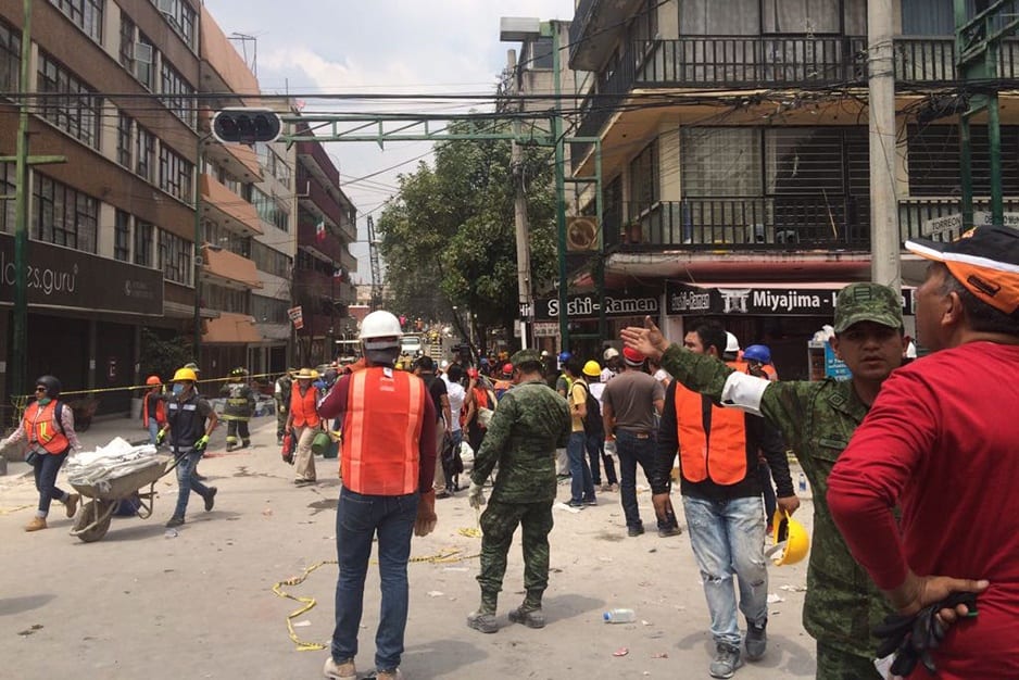 Workers clear rubble in Colonia Doctores, a neighborhood within Mexico City, following a 7.1-magnitude earthquake Tuesday afternoon.