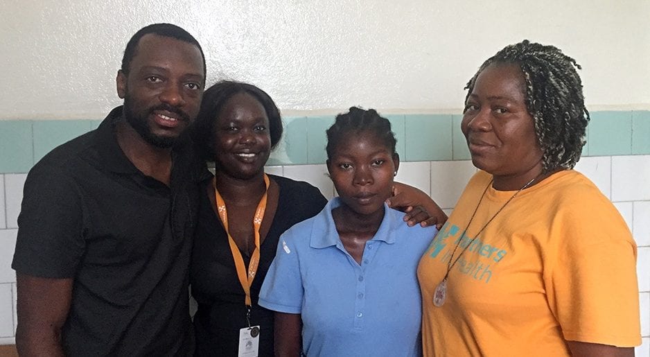 Patient Mable Elliot and members of PIH-Liberia pause for a photo in J.J. Dossen Hospital