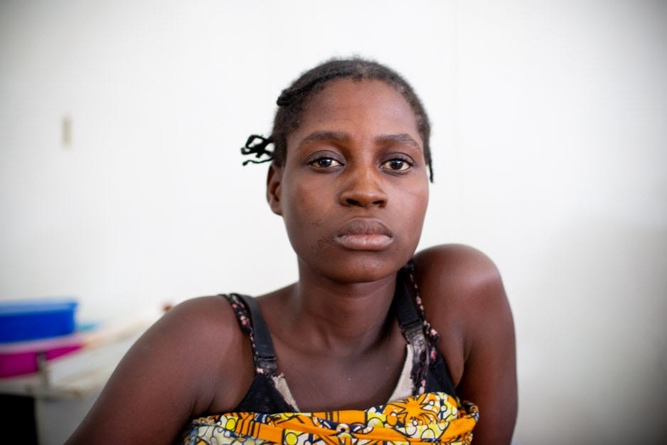 Portrait photo of female patient at a PIH clinic in Malawi