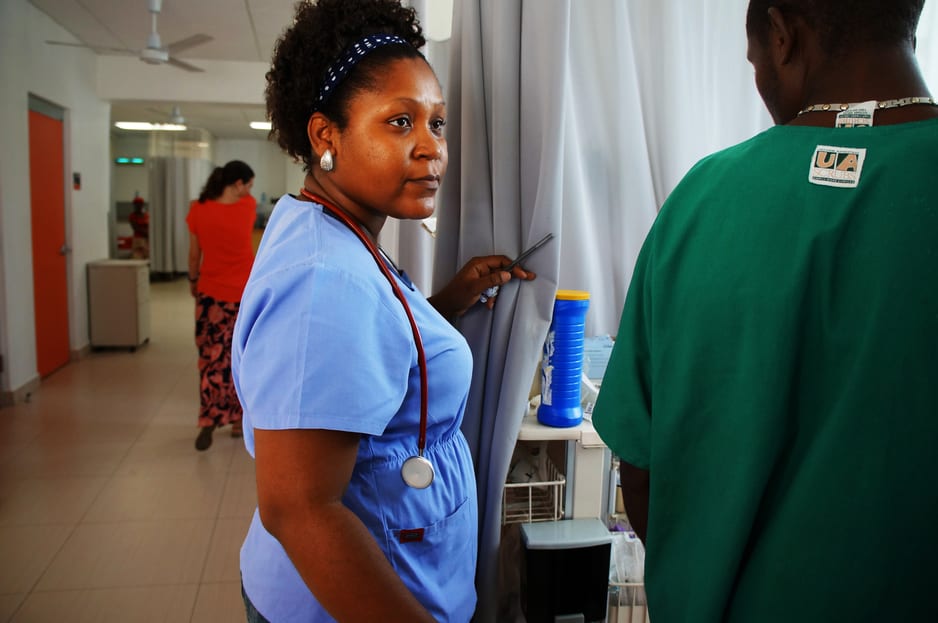 Dr. Mirrielle Bien-Aime checks on a patient in University Hospital's emergency room