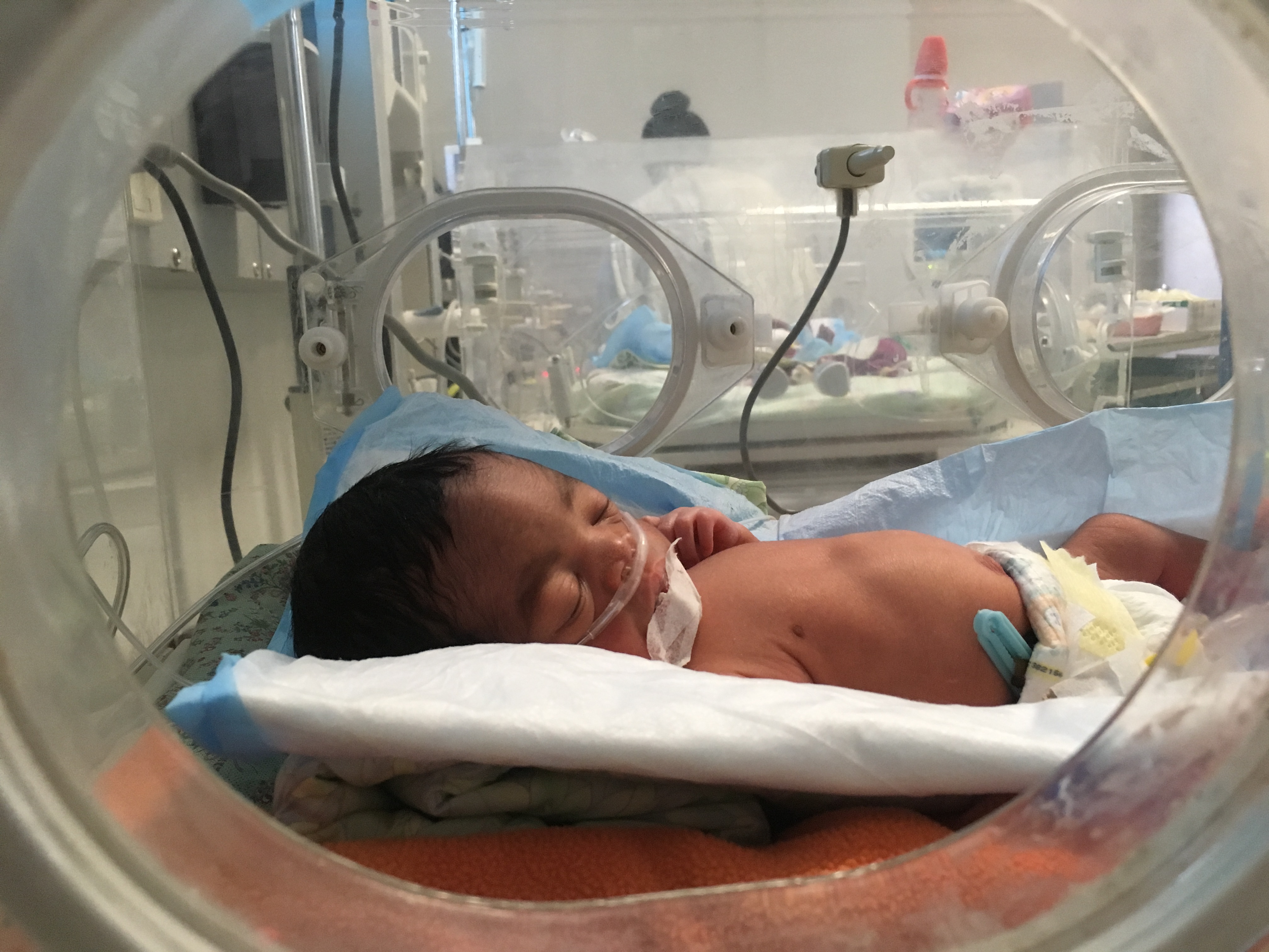 One of the quadruplets rests in an incubator in the NICU unit in University Hospital
