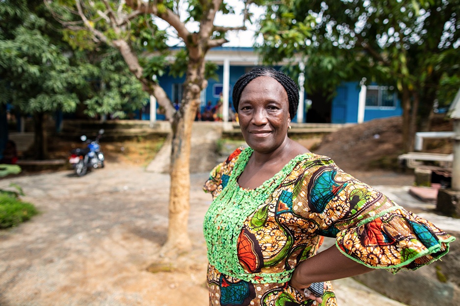 PIH Sierra Leone midwife Boyama Gladys Katingor stands outside Wellbody clinic