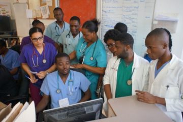 Morning shift change in the emergency department at University Hospital in Mirebalais with doctors and residents.