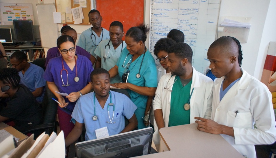Morning shift change in the emergency department at University Hospital in Mirebalais with doctors and residents.
