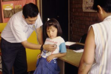 Scene from Bending the Arc documentary where Dr. Jaime Bayona provides medical care in the neighbourhood of Cristo Luz del Mundo in Carabayllo, Peru.